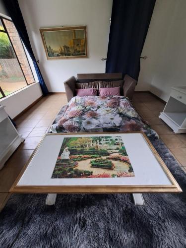 a bed in a room with a rug on the floor at La Château B&B in Springs