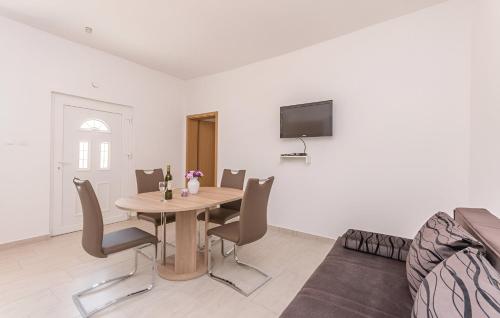 a dining room with a wooden table and chairs at Elegant Villa Jure with private pool in Poličnik