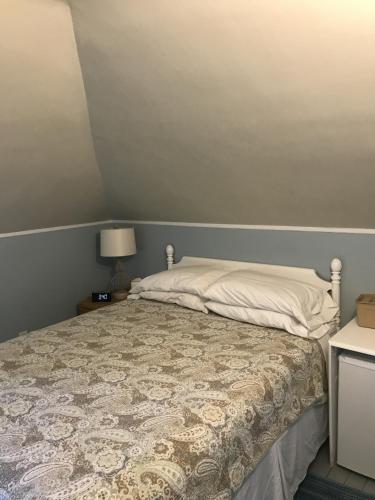 a bedroom with a bed with a quilt on it at The John Randall House in Provincetown