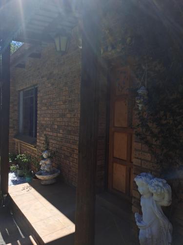 a brick building with a door and a window at La Château B&B in Springs