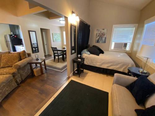a bedroom with a bed and a living room with a couch at The Overlook~Bandera, TX in Bandera