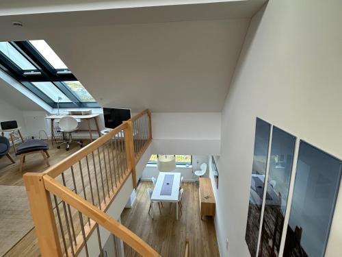 an attic room with a staircase and a bedroom at Tor zum Meer in Helgoland