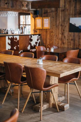 a wooden table and chairs in a room at La Ferme du Golf in Megève