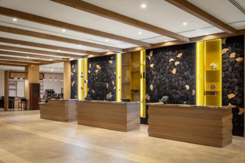a lobby with wooden counters and a wall of rocks at DoubleTree By Hilton Sacramento in Sacramento