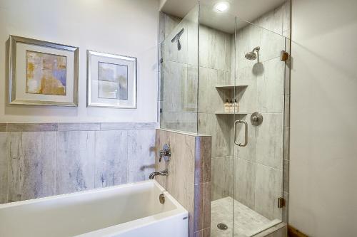 a bathroom with a shower and a bath tub at Park City Townhome with Hot Tub and Mountain Views! in Heber City