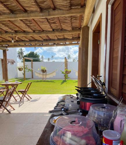a stove with pots and pans on a patio at Vila Mandakaru in São Miguel do Gostoso