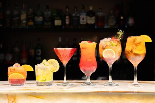 a group of four cocktails in wine glasses on a bar at Meliá Paulista in Sao Paulo
