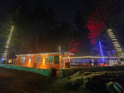 a small train car at night with lights at Pandora Riverside Cafe & Stay in Kasol