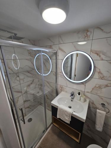 a bathroom with a sink and a shower at Tribeca Stay in Galway