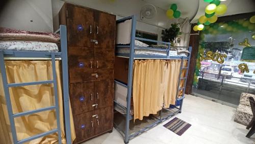 a bedroom with two bunk beds and a dresser at Laxmi Dormitory in Vrindāvan