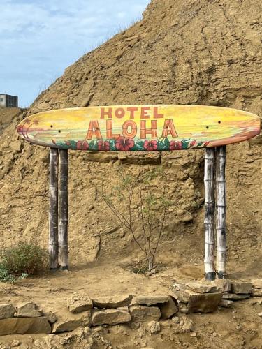 a sign that says hotel aloha on the side of a hill at Aloha Lobitos in Lobitos
