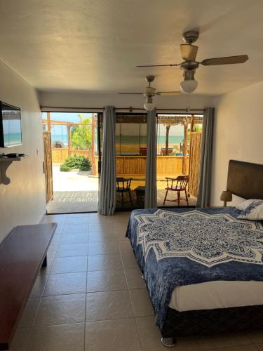 a bedroom with a bed and a view of a patio at Aloha Lobitos in Lobitos
