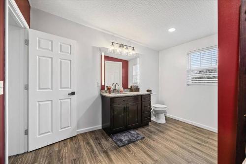a bathroom with a sink and a toilet and a mirror at Centrally located renovated home in Columbus