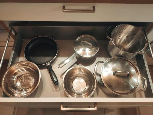 a bunch of pots and pans on a stove at Jacques Cartier - ideal lake of Nantua in Montréal La Cluse