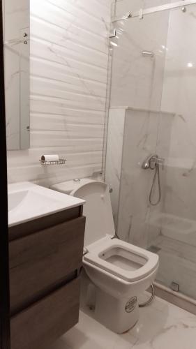 a white bathroom with a toilet and a shower at tranquil harmony in Casablanca