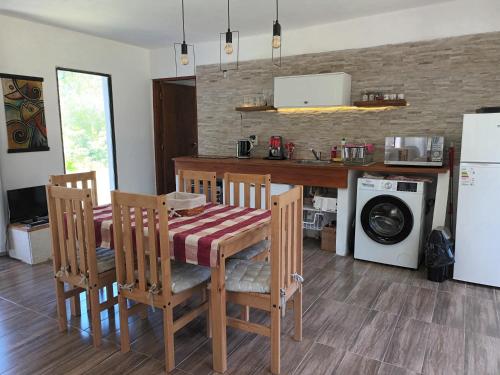 a kitchen with a table and chairs and a microwave at Casa muy luminosa , 2 d in José Ignacio