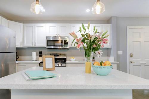 a kitchen with a counter with a vase of flowers on it at Apartment Located in Historic District Mins to Downtown, Beaches & Convention Center in Long Beach