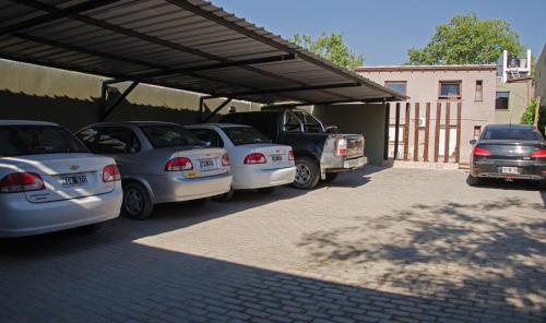 a group of cars parked under a garage at Munay Hotel Cafayate in Cafayate