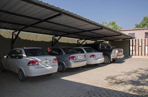 a group of cars parked under a parking lot at Munay Hotel Cafayate in Cafayate