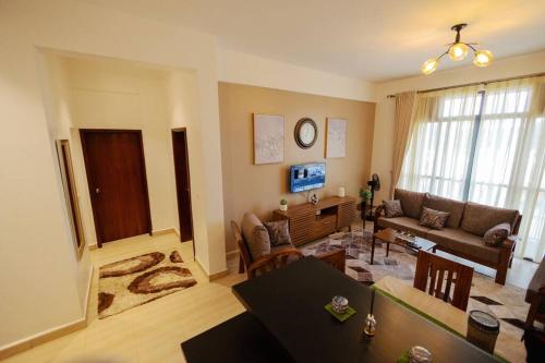 a living room with a couch and a table at Apartment in Entebbe 2 in Wakiso