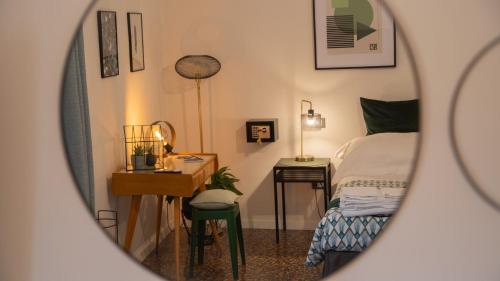 a bedroom with a bed and a desk and a mirror at Good Morning Bologna in Bologna