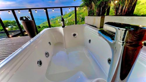 a bath tub sitting on top of a deck at Glamping Ocaso in Llanitos
