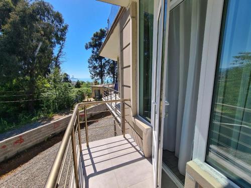 a balcony with a staircase leading to a door at Villa TG in Batumi