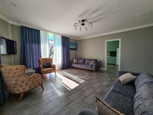 a living room with a couch and a chair at Villa TG in Batumi