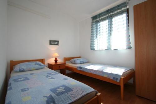 Postel nebo postele na pokoji v ubytování Apartment Ruzmarin
