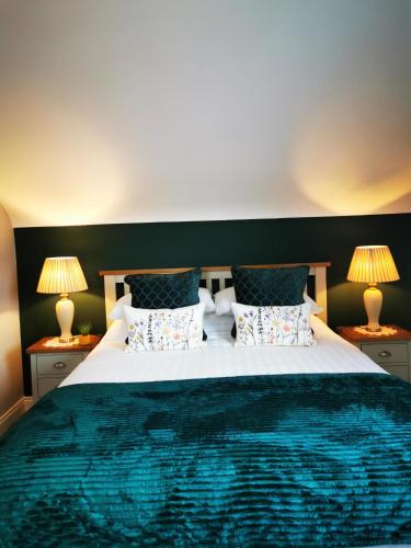 a bedroom with a large bed with two lamps at Ocean Heights B&B in Lissadell