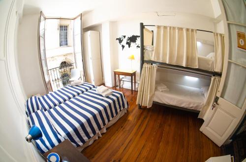 a small room with two beds and a window at BA Stop Hotel House in Buenos Aires