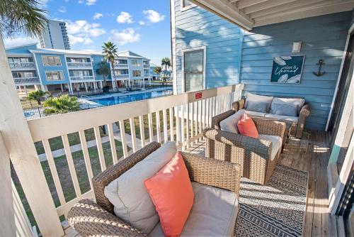 a balcony with two chairs and a couch on a porch at Sea Oats B105 by ALBVR - Pet Friendly - Balcony - Easy Beach Access! in Gulf Shores