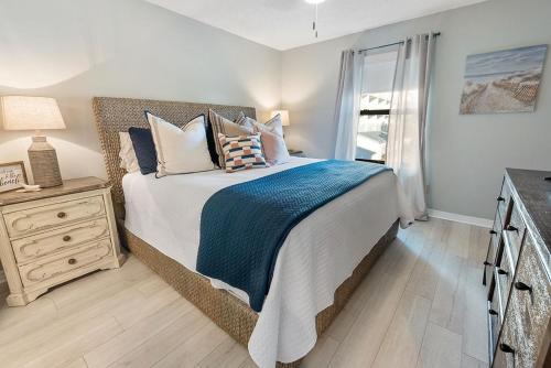 a bedroom with a large bed and a window at Sea Oats B105 by ALBVR - Pet Friendly - Balcony - Easy Beach Access! in Gulf Shores