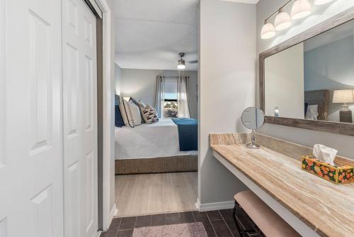 a bedroom with a bed and a large mirror at Sea Oats B105 by ALBVR - Pet Friendly - Balcony - Easy Beach Access! in Gulf Shores