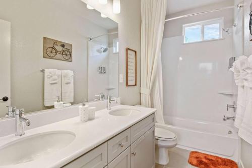 a white bathroom with a sink and a toilet at The haven @ Roc Sac in Rocklin