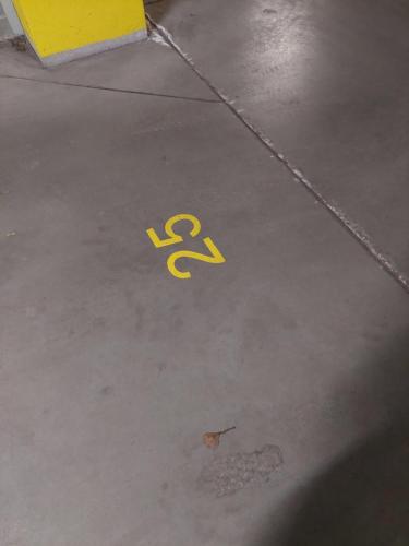 a handicapped symbol on the floor of a parking lot at Apartament in Legionowo