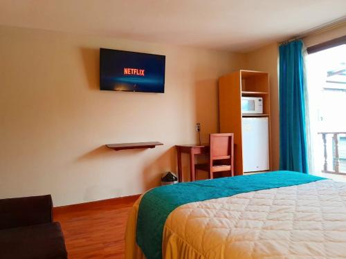 Ένα ή περισσότερα κρεβάτια σε δωμάτιο στο San Rafael Hotel