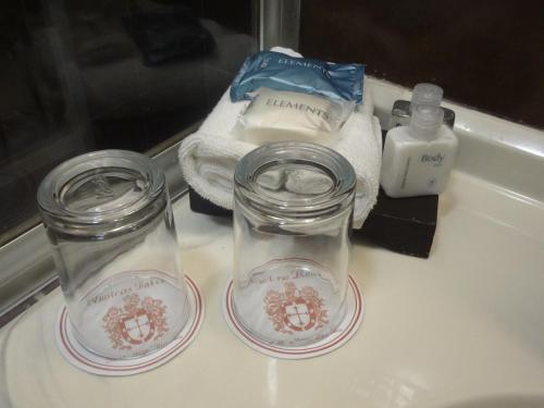 two glass jars sitting on top of a bathroom sink at Nuestras Raíces Hotel - Museo - Restaurante in San Cristóbal de Las Casas