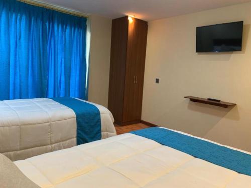 Ένα ή περισσότερα κρεβάτια σε δωμάτιο στο San Rafael Hotel