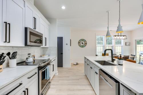 a kitchen with white cabinets and white counter tops at 2 Mi to Historic Dtwn Wilmington Luxe Family Home in Wilmington