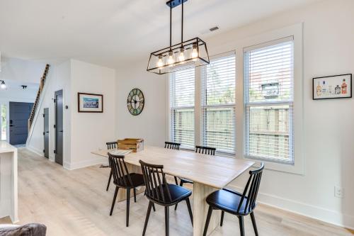 a dining room with a wooden table and chairs at 2 Mi to Historic Dtwn Wilmington Luxe Family Home in Wilmington