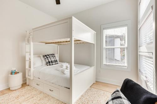 a white bunk bed in a white room with a window at 2 Mi to Historic Dtwn Wilmington Luxe Family Home in Wilmington