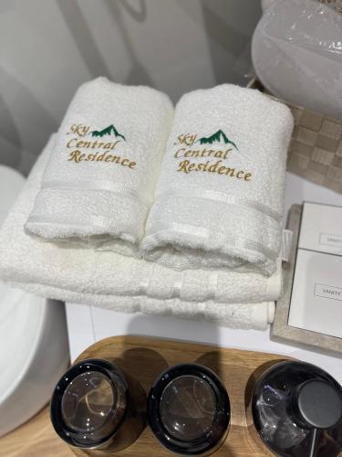 a couple of towels on a shelf in a bathroom at Lux apartment Sky Central Residence Zlatibor in Zlatibor