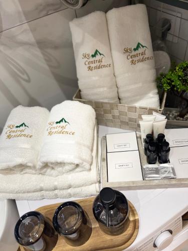 a shelf with towels and other products on it at Lux apartment Sky Central Residence Zlatibor in Zlatibor