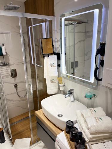 a bathroom with a sink and a shower at Lux apartment Sky Central Residence Zlatibor in Zlatibor