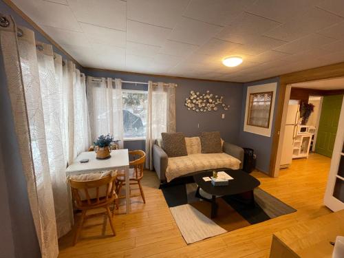 a living room with a couch and a table at Entire House and Home in Whitehorse Downtown in Whitehorse