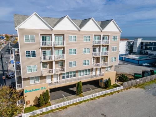 an apartment building with the ocean in the background at Beachview OC 2 Ocean Block in Ocean City