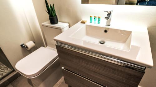 a bathroom with a sink and a toilet at Smart Brickell Hotel in Miami