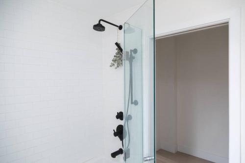 a glass shower in a bathroom with a glass door at Bright 3 bedroom house Downtown in Toronto