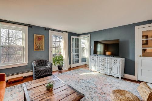a living room with a television and a couch at Lambertville Retreat - Walk to Shopping and Dining! in Lambertville